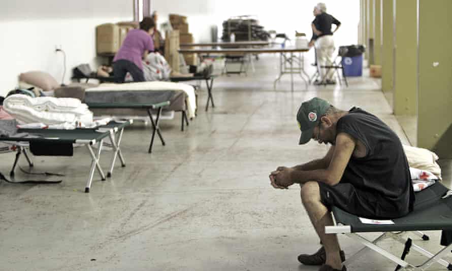 A man sits on a cot in an evacuation center at the Napa Valley Fairgrounds in Calistoga, California on Sunday.
