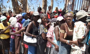 Hurricane Matthew victims wait to receive food from the UN’s World Food Program in Roche-a-Bateaux, in Les Cayes, south-west Haiti, on Wednesday.