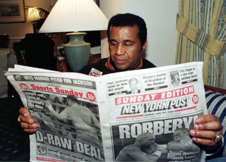 Lennox Lewis’s trainer in 1999, Emanuel Steward, reads the New York Post the day after his boxer’s controversial draw with Evander Holyfield.