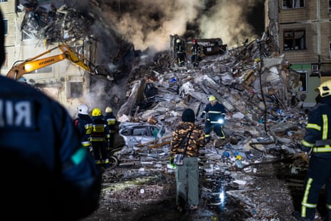 Emergency workers search the remains of a residential building that was struck by a Russian missile on Sunday.
