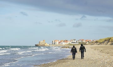 File photo of two French police officers walking with their backs to the camera at the beach in Wimereux near Calais