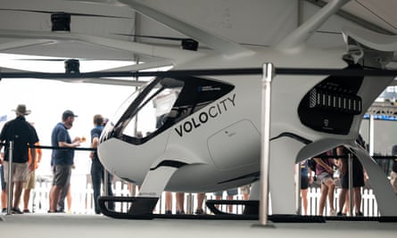 The VoloCity at Volocopter’s booth at EAA AirVenture with people waiting in line to sit in the electric air taxi model.