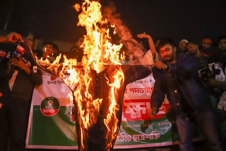 Protesters burn an effigy of a government official in Dhaka