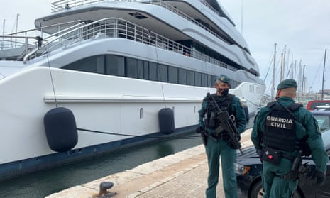 Spanish Civil Guards stand by the Tango superyacht docked in Palma de Mallorca, as it is searched by Spanish police and the FBI.