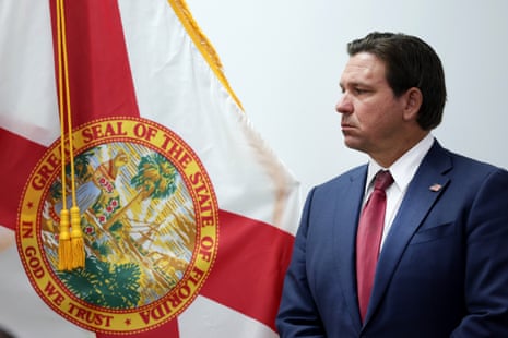 a man stands next to a flag