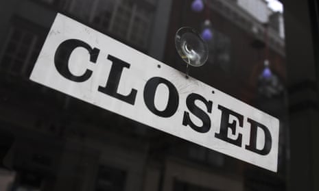 A closed sign is displayed in the door of a restaurant