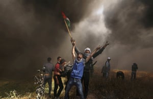 Palestinian demonstrators shout during clashes with Israeli troops at a protest demanding the right to return to their homeland at the border between Israel and Gaza.