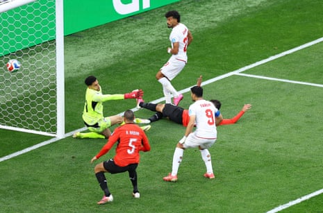 Ramin Rezaeian scores their first goal past Egypt's Mostafa Shoubir