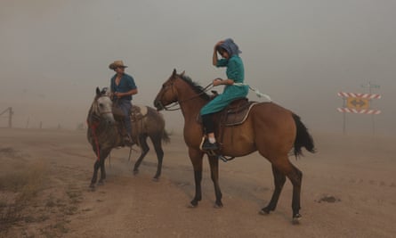 Horse riders surrounded by smoke from the Richard Spring fire as it moves toward Ashland, Montana.
