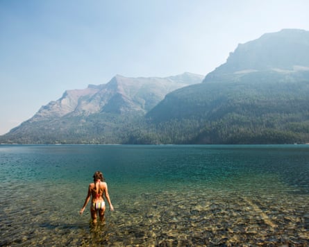 A young woman diving into a perfect lake