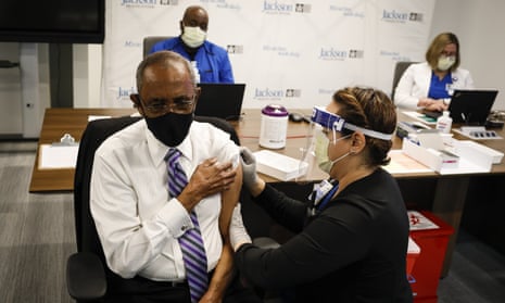 A healthcare worker administers a Covid vaccine in Miami, Florida. 