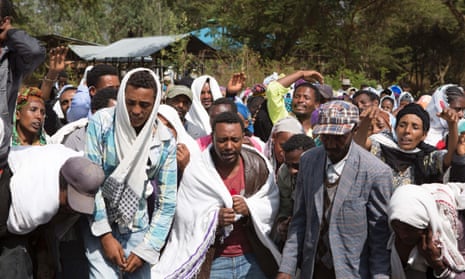 People mourn the death of a protester who was shot by Ethiopian forces in the Oromia region, 17 December.