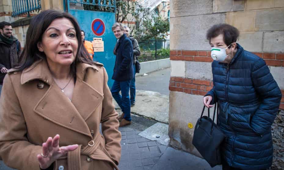 The mayor of Paris, Anne Hidalgo (left), in front of a polling station in the capital