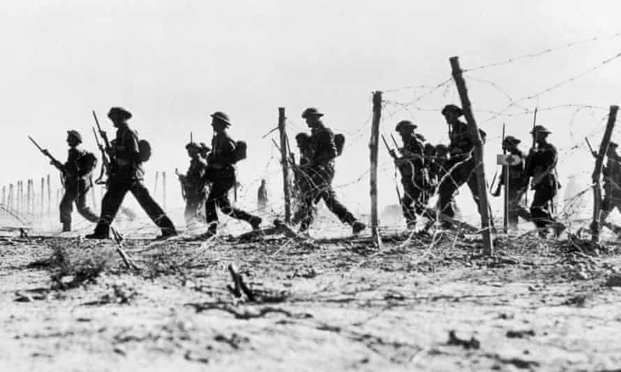 British infantry making their way through a gap in barbed wire defences during the advance on Tobruk.