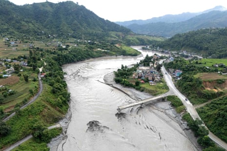 An aerial view shows the damaged Ghatbesi Bridge over the Trishuli River in the aftermath of flash floods in Nepal’s Dhading district.