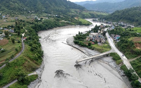 An aerial view shows the damaged Ghatbesi Bridge over the Trishuli River in the aftermath of flash floods in Nepal’s Dhading district.