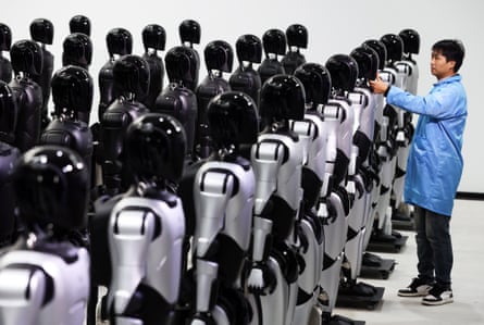 An engineer debugs robots at a robotics company in China.