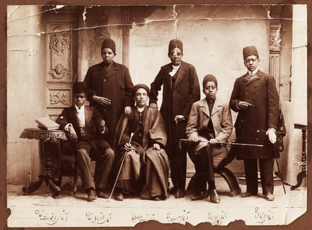 African slaves in Iran during the Qajar era were often eunuchs. Their dress suggests that they belonged to the king or high-ranking members of his court. From right: Aqay-i ‘Almas khan, Aqay-i Bahram khan, Aqay-i Masrur, Aqay-i A Seyid Mustafa, Aqay-i Iqbal khan, and Aqay-i Yaqut khan (different person from other photo), 1880s