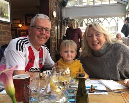 Denise and Stephen Burke with Ardy sitting at a table with drinks in front of them