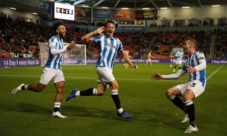 Jonathan Hogg celebrates after scoring Huddersfield’s third at Bloomfield Road.