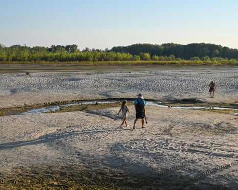 People walk across sandbars exposed by the low water level of the Danube River near Apatin, Serbia.