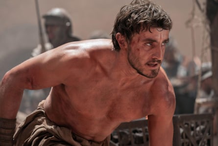 Paul Mescal crouched and topless as Lucius in Gladiator II