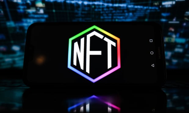 In this photo illustration, NFT logo is displayed on a smartphone with stock market percentages in the background in Poland, Jan 2022.
