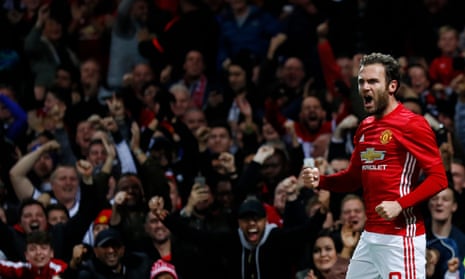 Mata celebrates scoring their first goal as the United faithful celebrates in the stands.