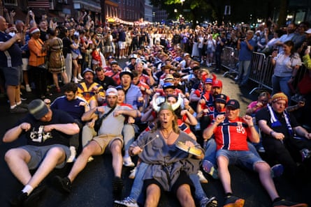 Scotland and Norway fans pretend to row an imaginary Viking longship in Boston