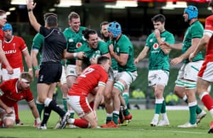 Ireland’s James Lowe celebrates with Will Connors and Chris Farrell after scoring their second try.