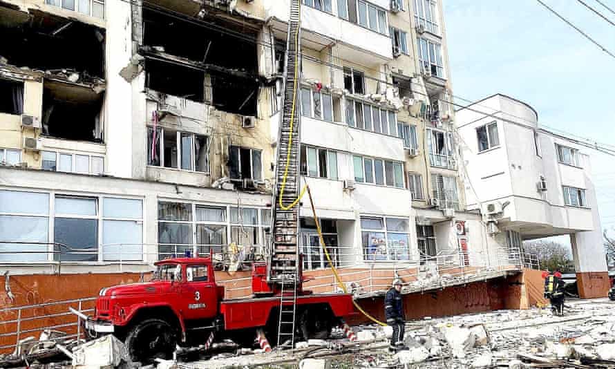 Emergency service workers rescue people after a missile strike in Odesa Oblast