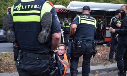 Dutch police detain a climate protester in The Hague