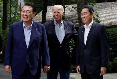 US President Joe Biden, Japanese Prime Minister Fumio Kishida and South Korean President Yoon Suk Yeol pose for photographs.