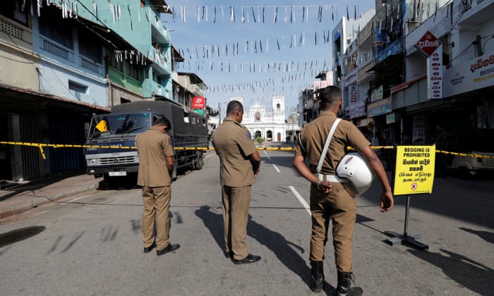 Security personnel observe silence as a tribute to victims near St Anthony Shrine in Colombo.