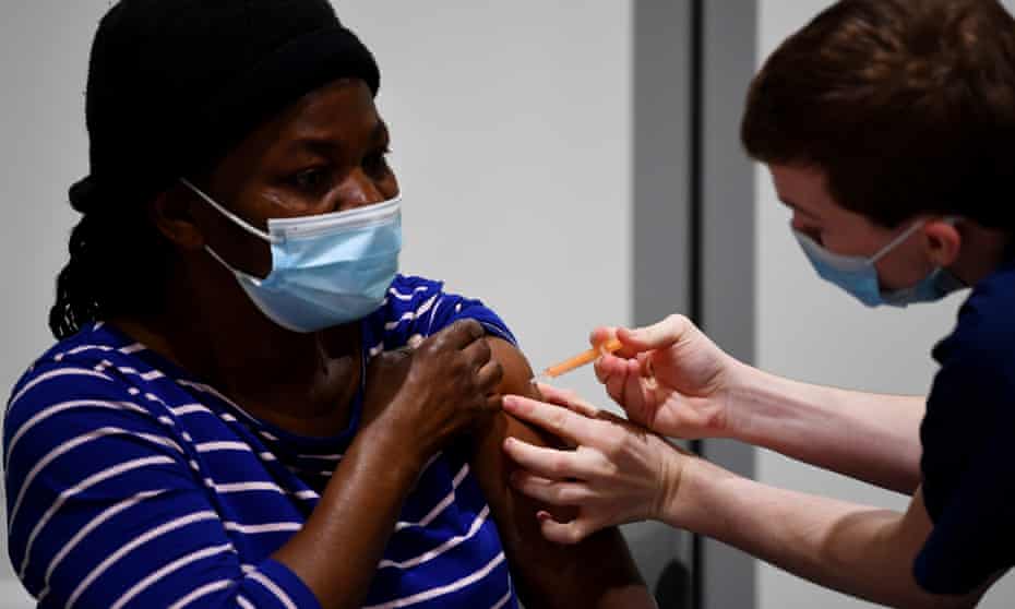 A woman receives her Covid vaccination in London.