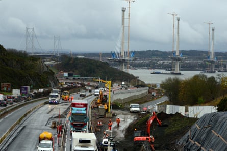 Traffic queues snake towards the Forth Road Bridge (left) from the north side of the firth. On the right is the replacement Queensferry Crossing under construction.