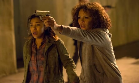 This image released by Universal Pictures shows Zoe Soul, left, and Carmen Ejogo in a scene from “The Purge: Anarchy.”