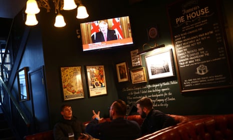 Boris Johnson appears on a television screen in a London pub.