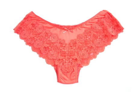 A pair of peach-colored lacy knickers on a white background