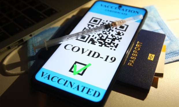 Stock illustration of a medical syringe, a passport and a smartphone with text saying ‘Vaccination certificate Covid-19, vaccinated’