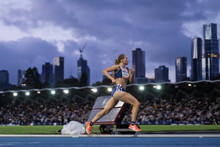 Jenny Blundell races during the women’s 3,000m with the Melbourne skyline in the background