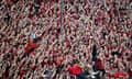 Bayer Leverkusen’s Xabi Alonso stands on a barrier as he celebrates with players and fans after winning the Bundesliga