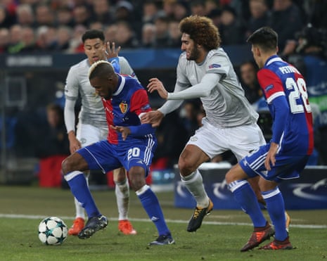 Marouane Fellaini of Manchester United in action with Geoffroy Serey Die of FC Basel.
