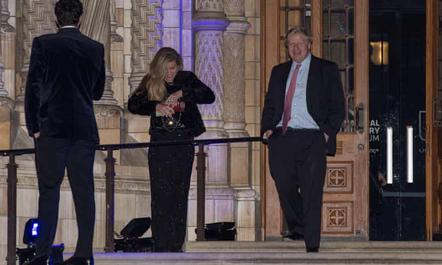 Boris Johnson, then foreign secretary, passes Carrie Symonds as he leaves the Conservative party Black and White Ball in February 2018.