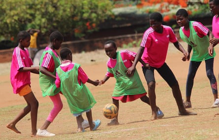 Young players on a dusty football pitch in Malawi