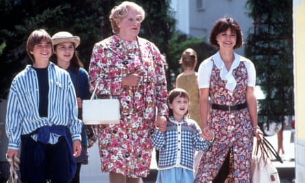With the family, she holds the hand of Robin Williams dressed as Mrs Doubtfire