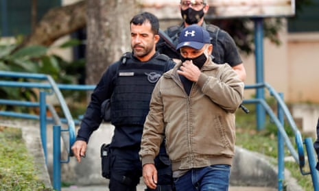 Fabrício Queiroz is led away after being arrested in Atabaia