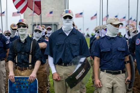 Far-right marchers in khakis and masks with homemade shields.
