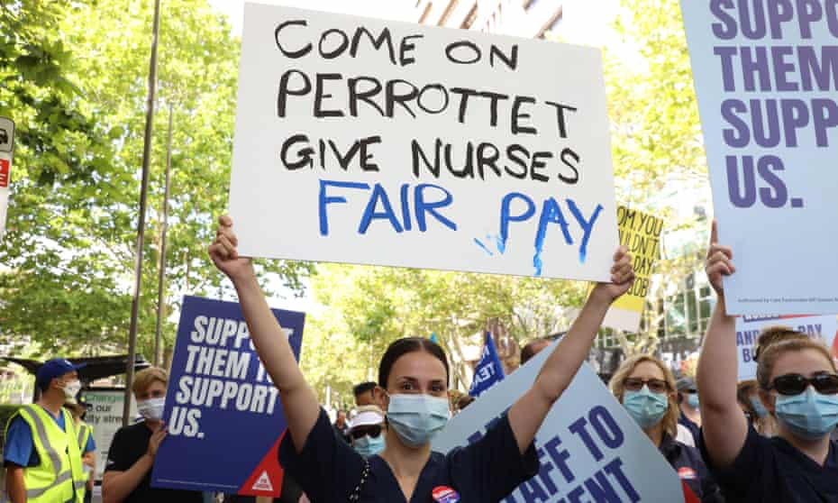 NSW Nurses and Midwives' Association (NSWNMA) members march from Queen's Square to the NSW Parliament building on Macquarie Street.