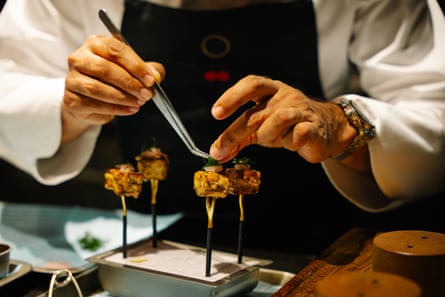 A chef puts the finishing touches to a delicate dish